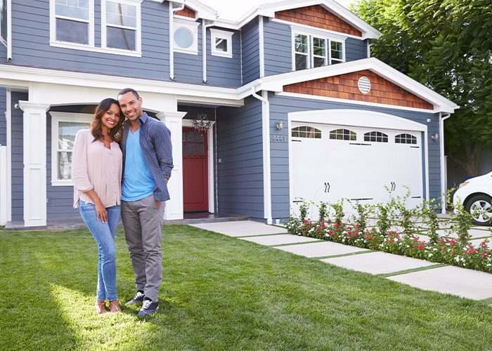 couple standing outside their home